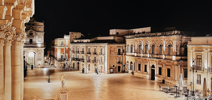 Piazza Duomo, Ortigia Piazza Duomo on Ortigia lit at night, baroque facades along the square with the cathedral columns at the left